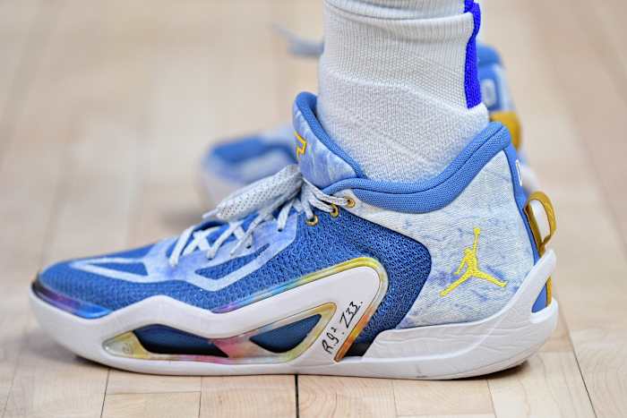 Side view of Jayson Tatum's blue and gold Jordan Brand sneakers.